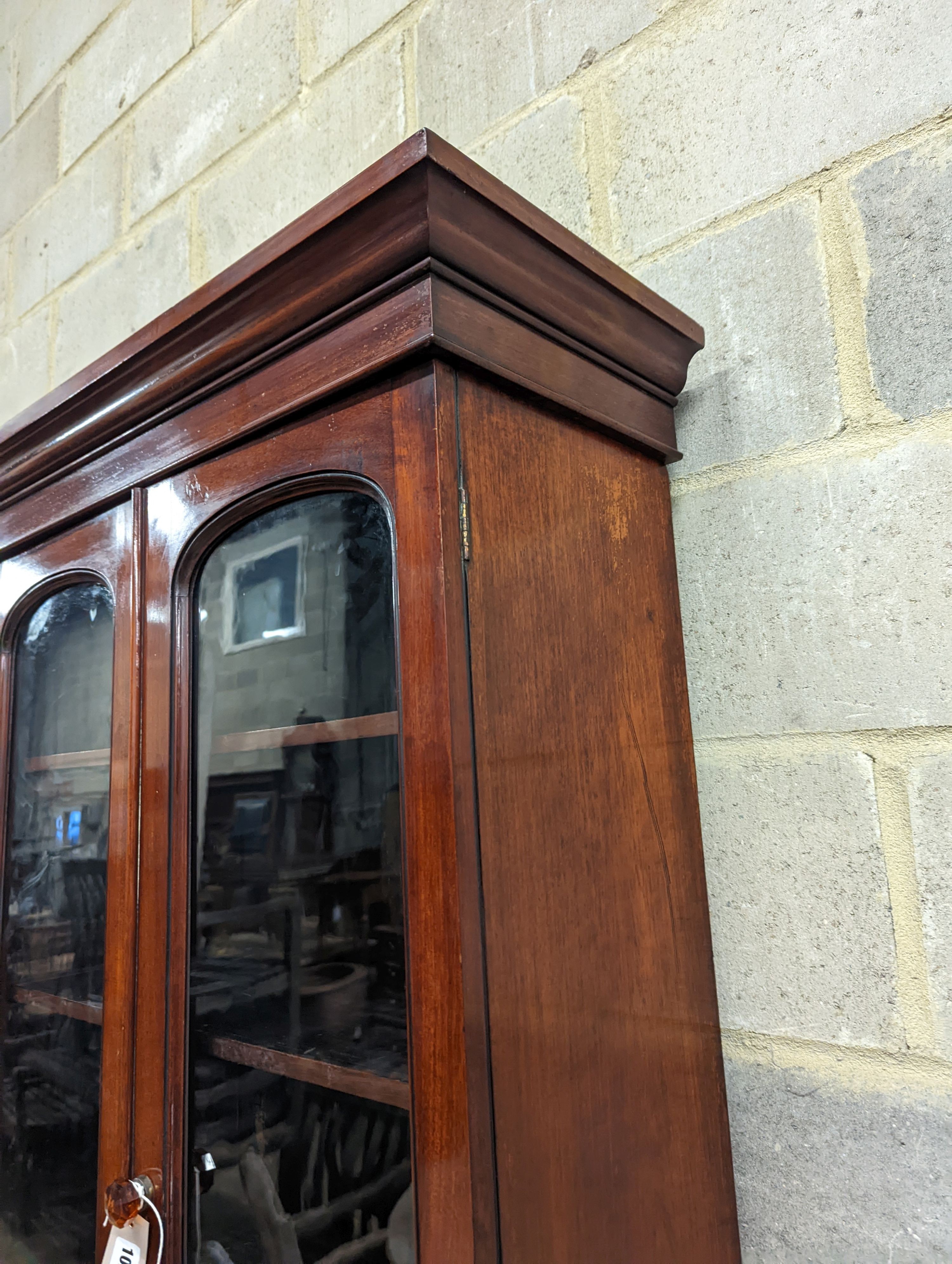 A narrow Victorian mahogany bookcase cupboard, width 71cm, depth 46cm, height 218cm